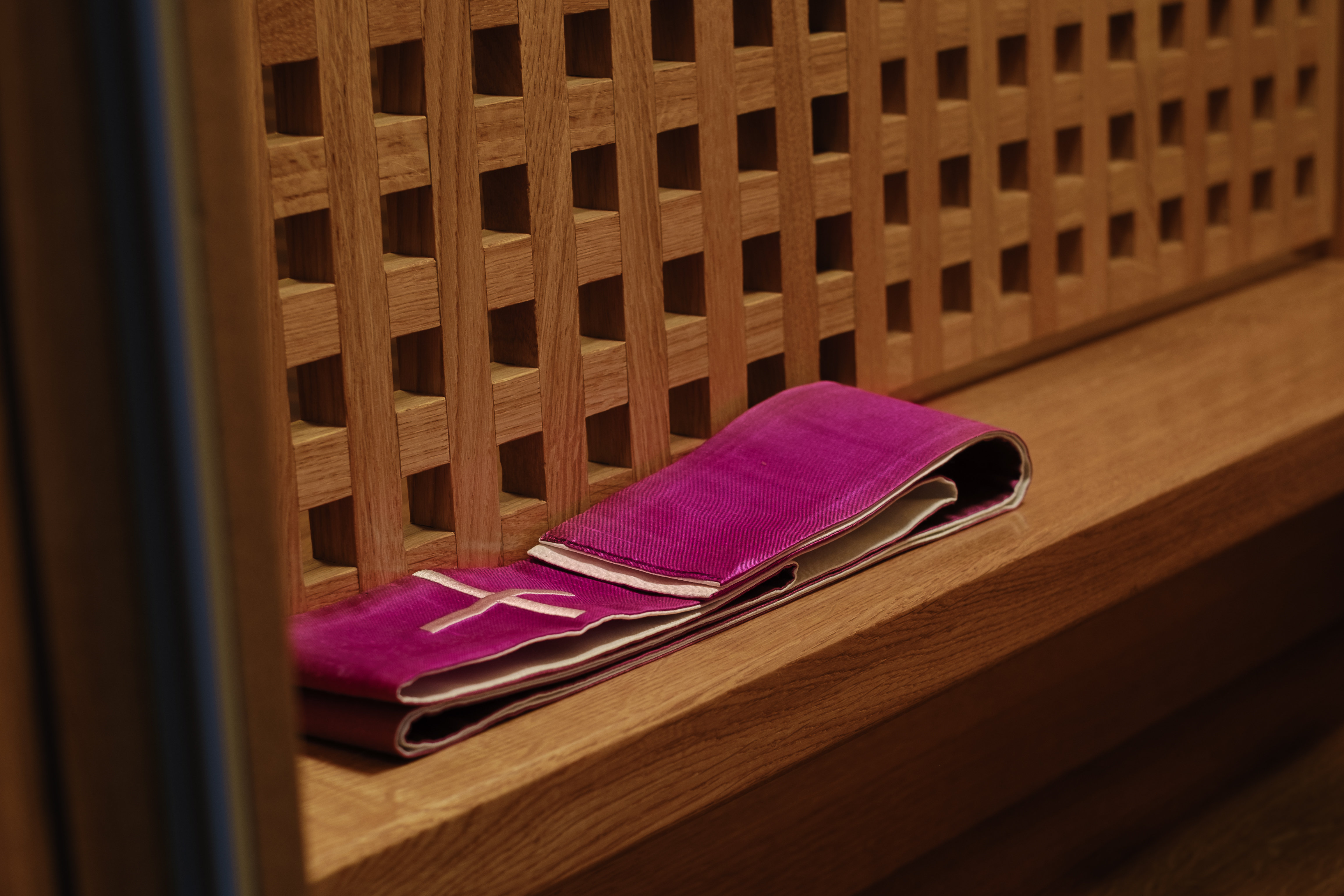 Beichtstuhl, davor gefaltete violette Stola